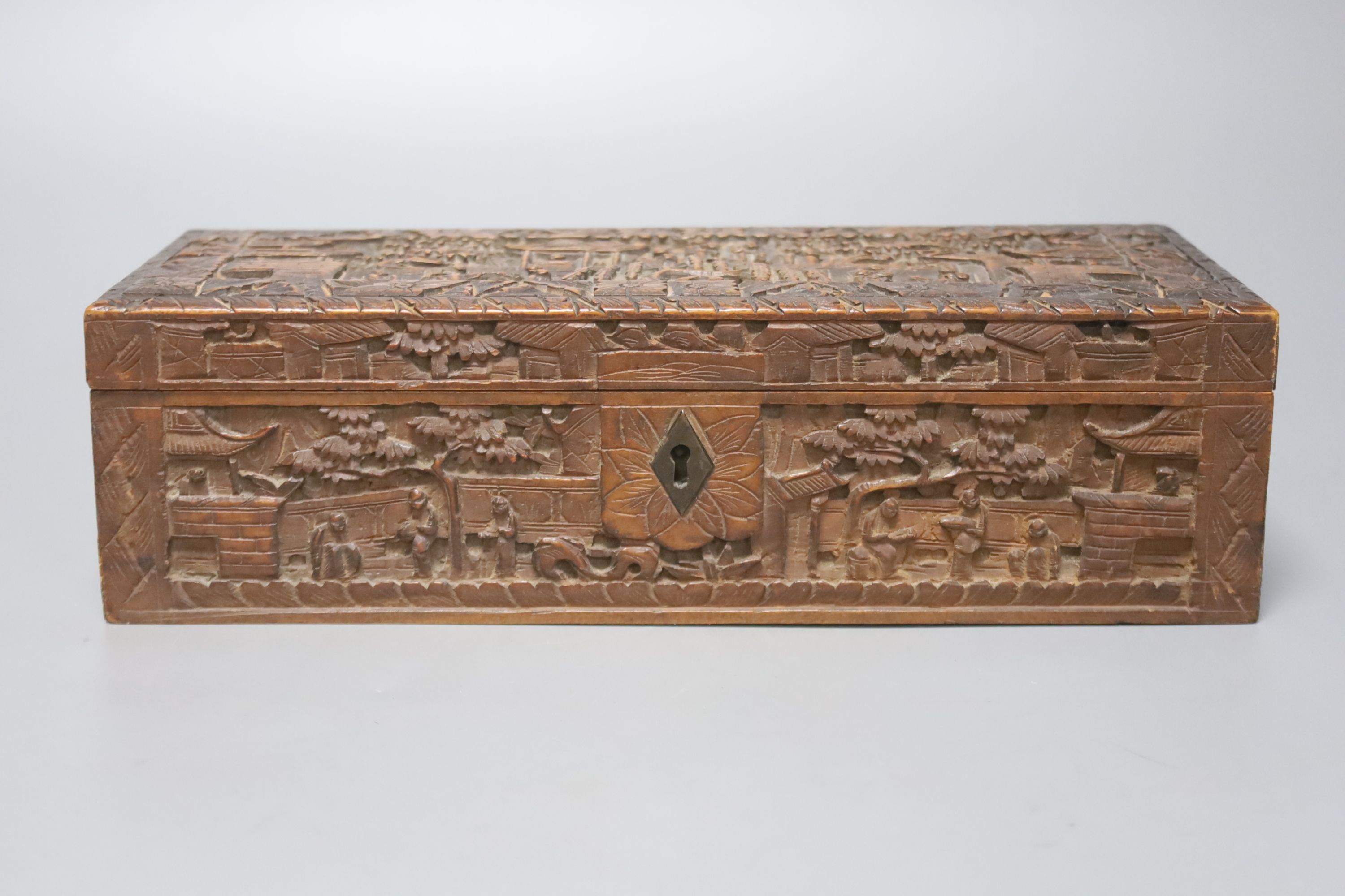 Two 19th century Chinese carved sandalwood boxes, together with a similar puzzle box, length 27cm